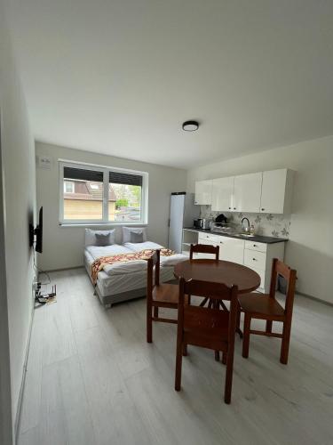 a kitchen and a bedroom with a bed and a table at Sun-House Pension&Restaurant -ParkingFree- in Prague