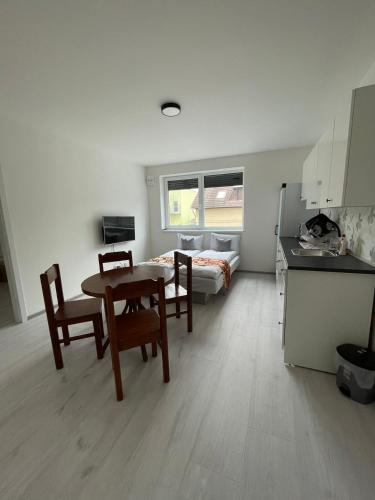 a kitchen and dining room with a table and chairs at Sun-House Pension&Restaurant -ParkingFree- in Prague