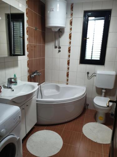 a bathroom with a tub and a sink and a toilet at Zelena dolina-Green Valley in Travnik