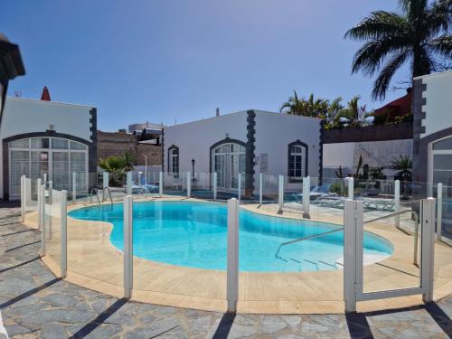 a swimming pool in the middle of a building at Nora Retreat (Fully Renovated) in Corralejo
