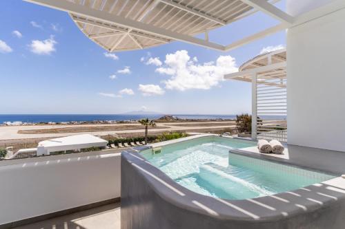 a swimming pool with a view of the ocean at Marvarit Suites in Mesaria