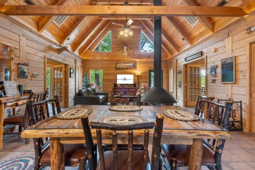 a dining room with a wooden table and chairs at Moose Lodge w/HotTub in Ridgedale