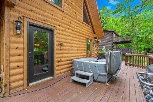 a deck with a bath tub on a house at Moose Lodge w/HotTub in Ridgedale