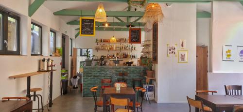 a restaurant with tables and chairs and a bar at YASI Hostel in Lyon