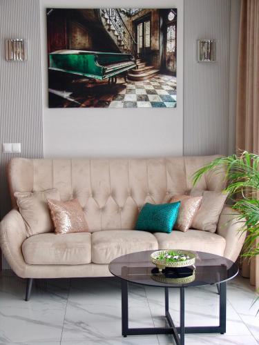 a living room with a couch and a table at Apartment LUXOR - Airport Katowice-Pyrzowice in Bobrowniki