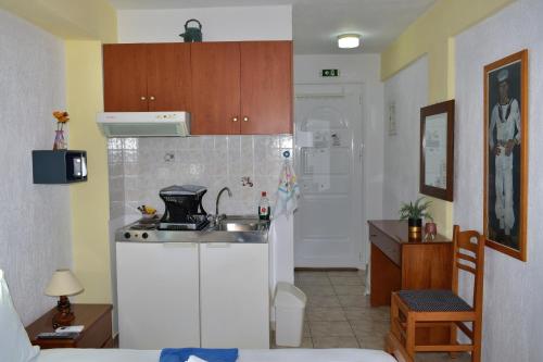 a kitchen with a sink and a counter top at Pansion Pandora in Skiathos Town