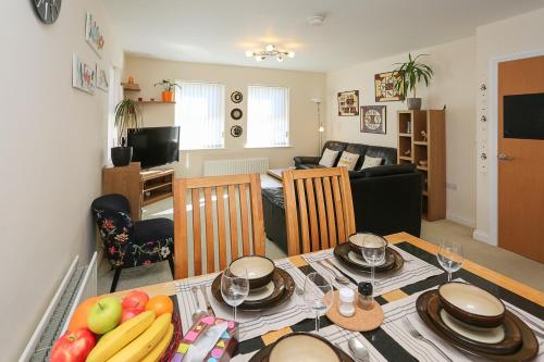 a kitchen and living room with a table with fruit on it at 3Bed/2Bath Duplex Apartment - Pure Bliss Belfast in Belfast