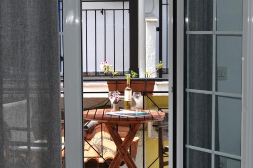 a balcony with a table and a window at Pansion Pandora in Skiathos Town
