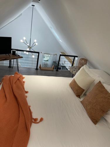 a bedroom with a large white bed with two pillows at Modern Loft in East Rockaway