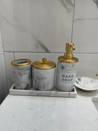 three candles sitting on a shelf in a kitchen at Modern Loft in East Rockaway