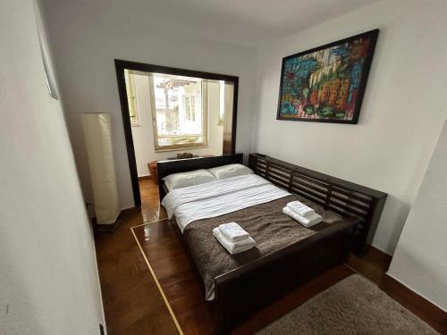 a bedroom with a bed with two towels on it at Pensiunea Lorena in Bran