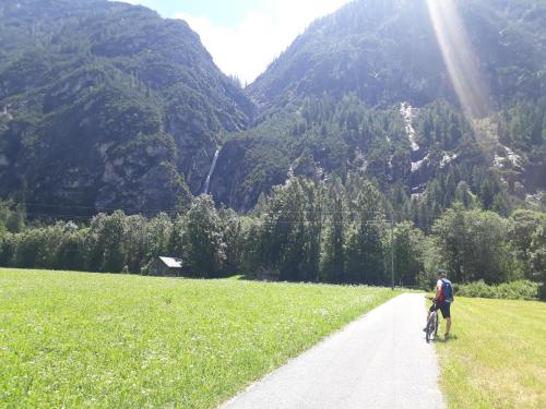 a man walking a dog on a dirt road at Pension Leitner in Hofen