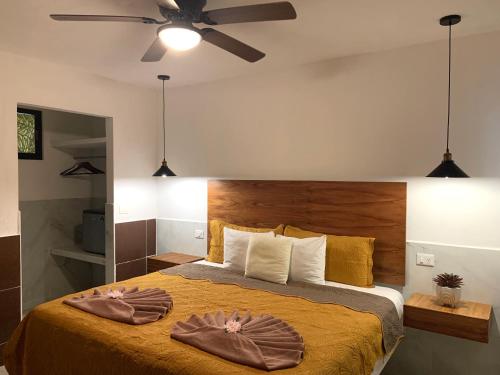 a bedroom with a bed with two towels on it at Hotel La Casa del Capi in Holbox Island