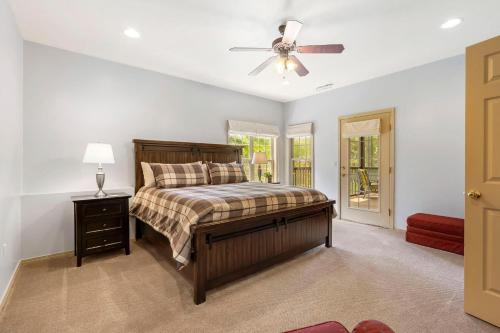 a bedroom with a bed and a ceiling fan at Fairway of Dreams in Reeds Spring