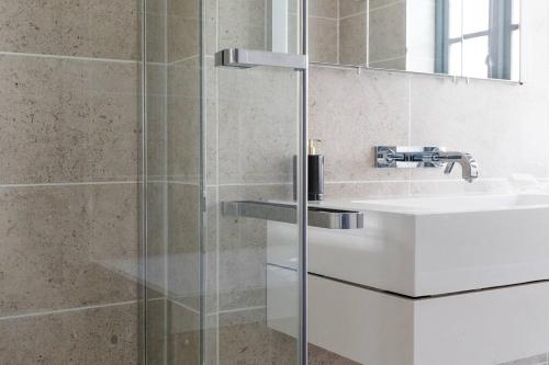 a bathroom with a shower and a sink at A beautiful Georgian town house in Painswick in Painswick