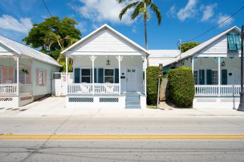 a row of white houses on a street at Crawl to Duval w/ Hot tub in Key West