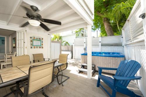 a patio with a table and chairs and a pool at Crawl to Duval w/ Hot tub in Key West