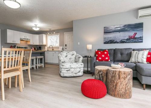 a living room with a couch and a table at Lovely 2 bedroom suite steps from The beach in Victoria