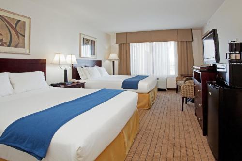 a hotel room with two beds and a television at Holiday Inn Express & Suites Buffalo, an IHG Hotel in Buffalo