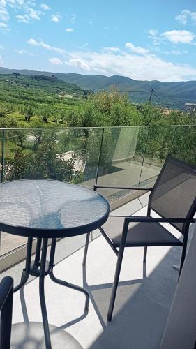 a table and two chairs on a balcony with a view at La Torre Studio in Alikanas