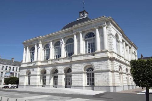 a large white building with a tower on top of it at Studio en plein cœur de ville in Saint-Omer