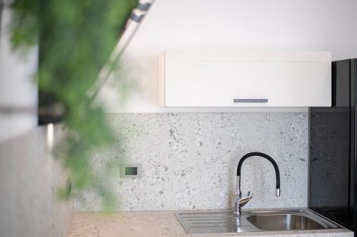 a kitchen counter with a sink and a faucet at 4 ELEMENTS in Tar