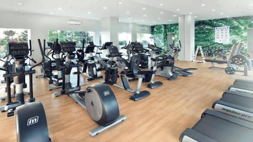 a gym with a bunch of treadmills and exercise bikes at Laureano Trevi Residences Makati Suites Condotel in Manila