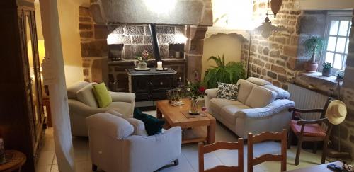 a living room with two couches and a table at chambre familiale 4 pers SDB partagée sans TV in Le Saint