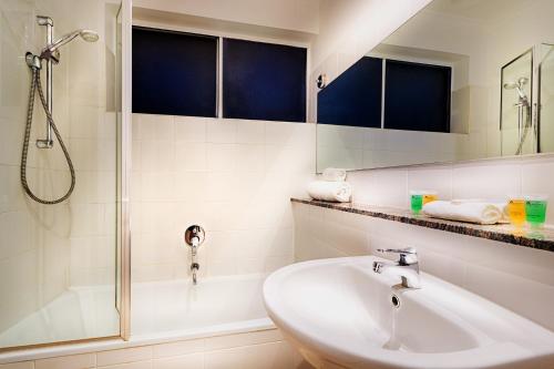 a bathroom with a sink and a shower at Crest on Barkly Hotel in Melbourne