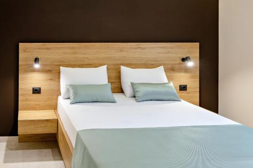 a bedroom with a large bed with two pillows at Apartments Piano in Utjeha