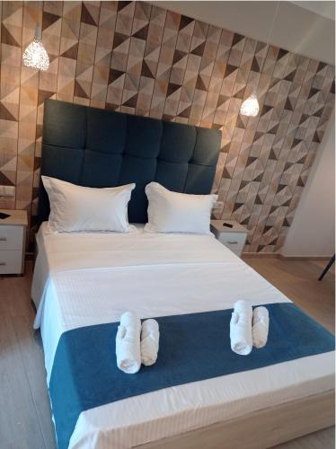 a bedroom with a bed with white slippers on it at Shining Star Petra in Petra