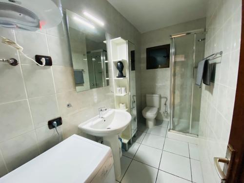 a bathroom with a sink and a shower and a toilet at CASA ATLANTICO in Puerto del Carmen