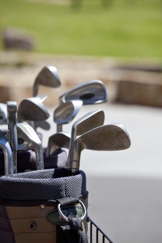 a row of golf clubs lined up in a rack at Oaks Lake Crackenback Resort in Crackenback