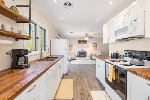 a kitchen with white cabinets and wooden counter tops at Relaxing 2-Master Suite Mountain Top - Fire Pit in New Market