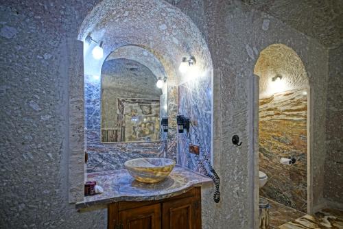 a bathroom with a bowl sink and a mirror at MDC Cave Hotel Cappadocia in Ürgüp