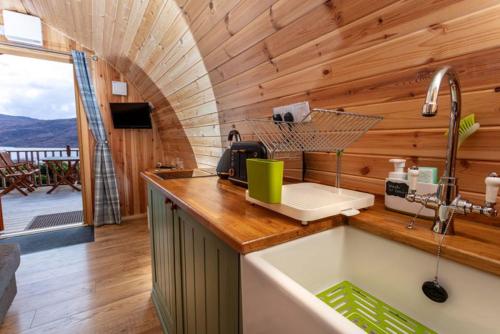 a kitchen with a counter with a sink in a room at The Highland Bothies Glamping in Ullapool