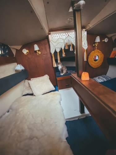 a small room with a bed and a mirror at Lady Blue Yacht in Nida in Nida