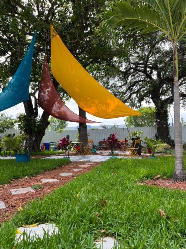 a group of flags hanging from trees in a park at Stunning Little Havana Suites Close to airport, Calle Ocho, Brickell, Wynwood and the Beaches - Free Parking in Miami