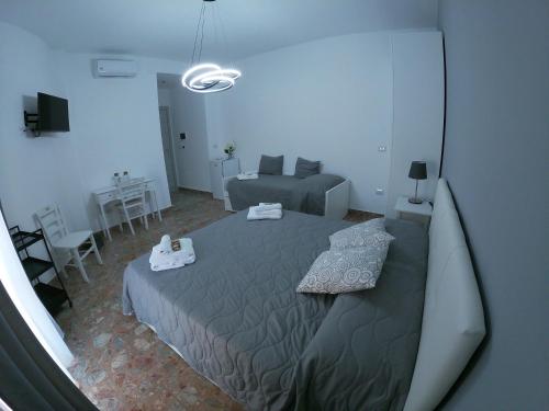 a bedroom with a large bed and a couch at B&B LA GIARA ART in Gallipoli