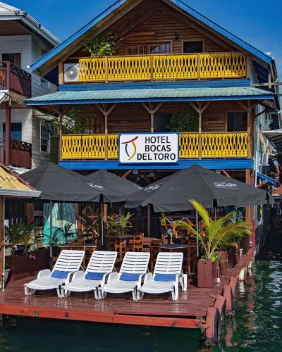 a group of chairs and umbrellas on a dock at Hotel Bocas del Toro in Bocas del Toro