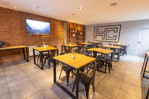 a dining room with wooden tables and chairs at HOTEL CONCEPT BARILOCHE in San Carlos de Bariloche