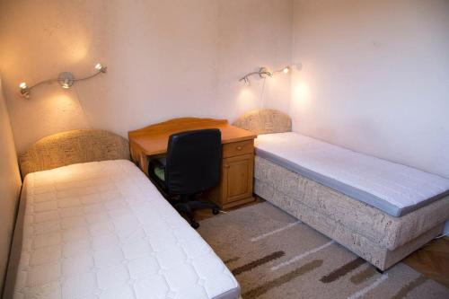 Pokój z 2 łóżkami, biurkiem i biurkiem w obiekcie Apartment Filip w Barze