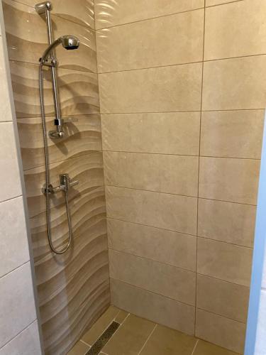a shower in a bathroom with a shower curtain at Apartmani Gojko in Biograd na Moru