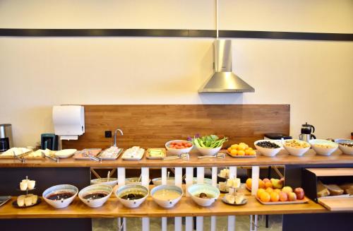 a kitchen with many bowls of food on a counter at Roof 264 Hotel & Suites in Sakarya