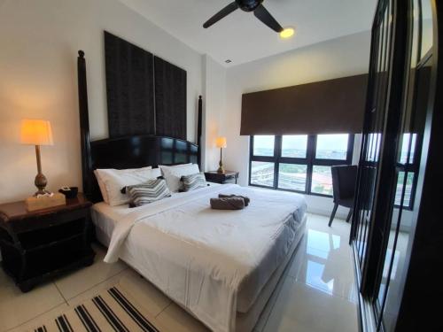 a bedroom with a large white bed and a window at Alpha LaVista at Emira Residence Shah Alam in Shah Alam