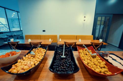 a table with three bowls of fruit on it at Roof 264 Hotel & Suites in Sakarya
