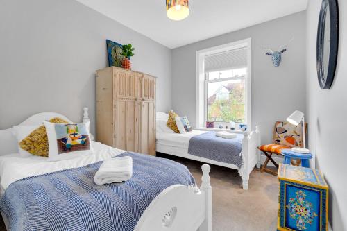 a bedroom with two beds and a window at Poets Apartment with Free Parking By My Getaways in Worthing