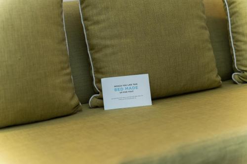 a sign sitting on top of a bed with a pillow at Radisson Hotel Santo Domingo in Santo Domingo