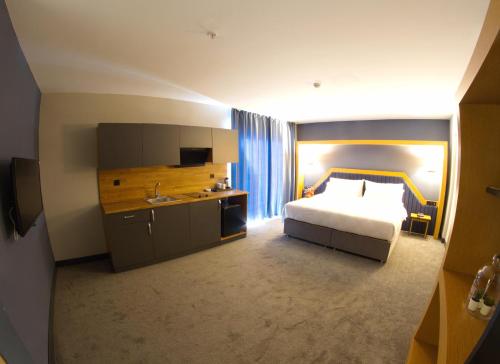 a hotel room with a bed and a sink at Roof 264 Hotel & Suites in Sakarya