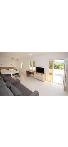 a living room with a couch and a tv at NACIONAL in Trebinje